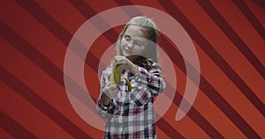 Child eating banana and complaining to camera
