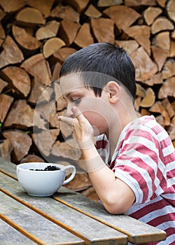 Child eating berries at the garden table