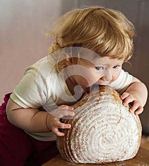 A child eating big bread photo