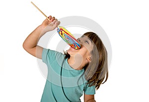 Child eating big lollipop candy isolated on white background in children love sweet sugar concept and dental health care concept