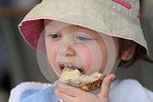 Child eating a bread photo