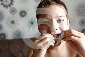 Child eating bread with chocolate butter