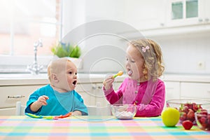 Child eating breakfast. Kid with milk and cereal