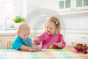 Child eating breakfast. Kid with milk and cereal