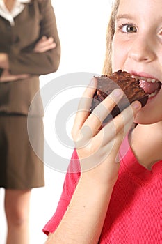 Child eating brownie upclose -