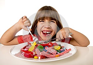 Child eating candy like crazy in sugar abuse and unhealthy sweet nutrition concept