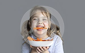 Child eating carrots. Healthy nutrition concept.Kid eats vegetables. Caucasian girl poprtrait