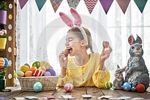 Child is eating chocolate eggs