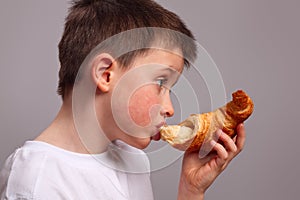 Child eating a croissant