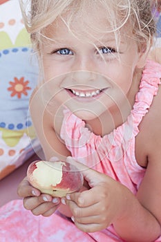 Child eating a flat peach