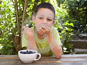 Child eating fresh blueberries
