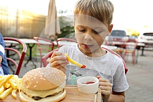 Child eating fries with ketchup