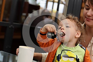 Child eating froth of coffee