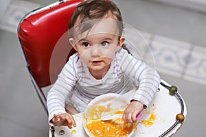 Child eating, high chair and food, nutrition and health for childhood development and wellness. Healthy, growth and