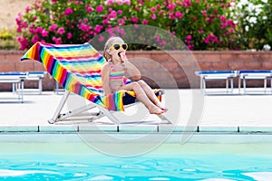 Child eating ice cream at swimming pool