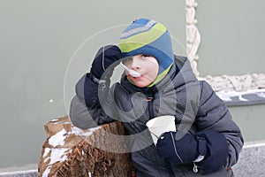 Child eating ice cream in winter