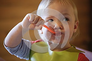 Child eating independently with a spoon