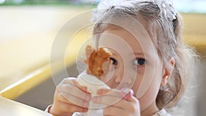 Child eating nuggets in the cafe. Portrait of a baby who eats fast food