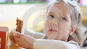 Child eating nuggets closeup. Portrait of a baby who eats fast food