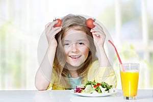 Child eating organic healthy food have a fun.