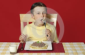 Child eating pasta