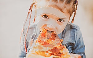 Child eating pizza. Fastfood for kids. Junkfood addiction. Italian cuisine. Children food. Childhood obesity. Tasty food