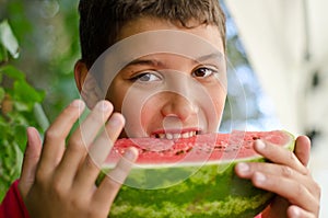 Child eating a slice of watermelon