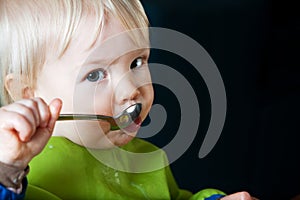 Child Eating with Spoon