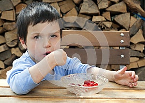 Child eating strawberries