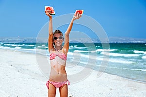 Child eating watermelon on the beach