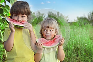 child eating watermelon in the garden