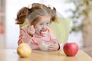 Child eating yogurt.