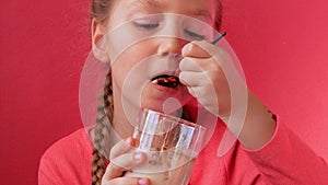 Child eating yogurt jelly pink background. Dairy product diet Lactobacillus Acidophilus, healthy homemade breakfast menu.