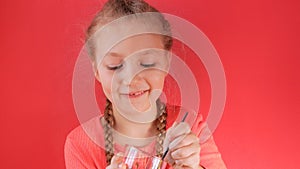 Child eating yogurt jelly on pink background. Dairy products kids diet, healthy homemade breakfast menu. Kids healthcare