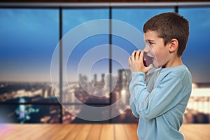 Child eats apple in the room