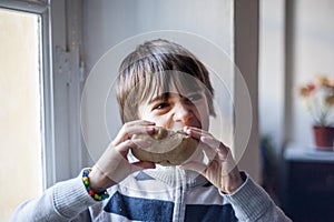 Child eats big homemade bread
