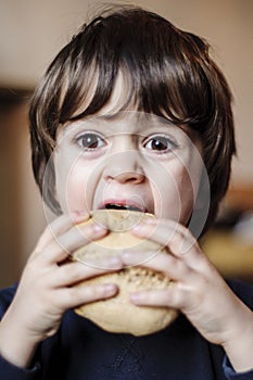 Child eats big homemade bread