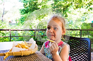 Child eats french fries. not healthy food