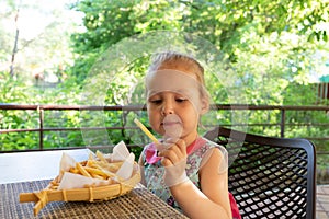 Child eats french fries. not healthy food
