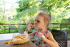 Child eats french fries. not healthy food