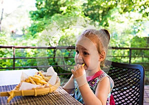 Child eats french fries. not healthy food