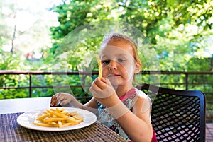 Child eats french fries. not healthy food