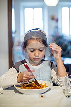 Child eats spaghetti