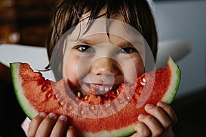 A child eats watermelon. Selective soft focus.