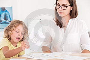 Child education therapist using props during a meeting with a kid with problems