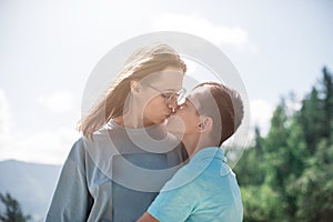 A child embraces mom in the mountain trip photo