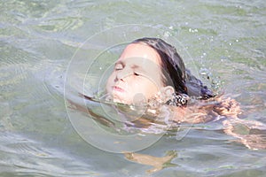 Child emerging from the sea