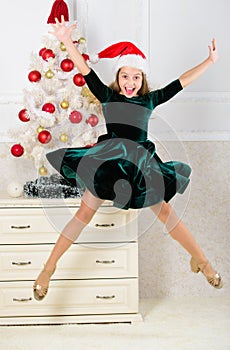Child emotional cant stop her feelings. Celebrate christmas concept. Girl in dress jumping. It is christmas. Day we have