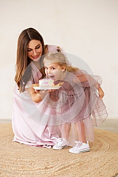 Child is emotionally eating a birthday cake. Birthday celebration.