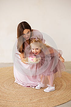 Child is emotionally eating a birthday cake. Birthday celebration.